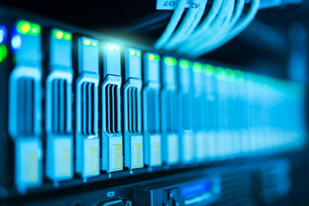 Close-up of data server and network cables with blue LED lights.